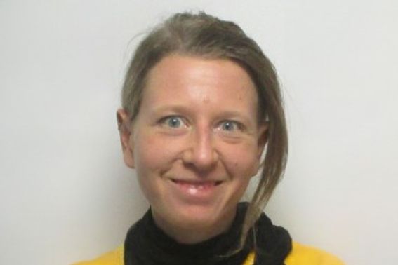 Headshot of Verena smiling against white backdrop