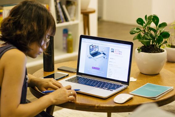 Student making notes at laptop