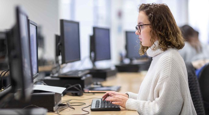 Female student working at a computer in a computer study room