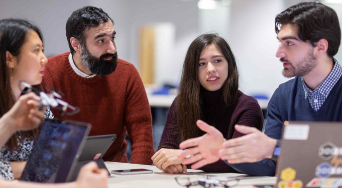 Group of students in discussion with a lecturer