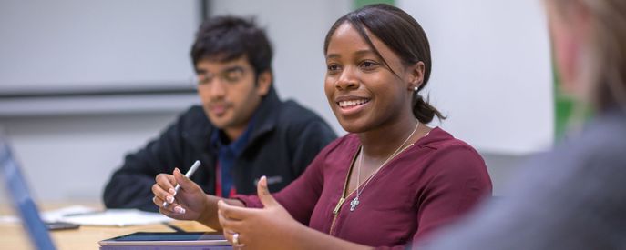A student takes part in a discussion during a class