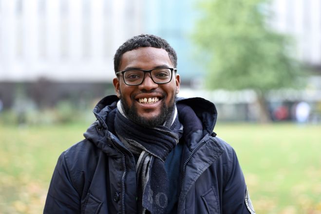 Scholar smiles at the camera