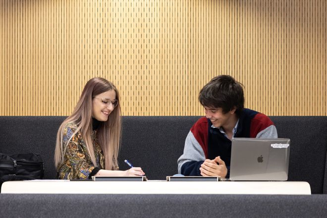 Students chatting in a breakout space on campus