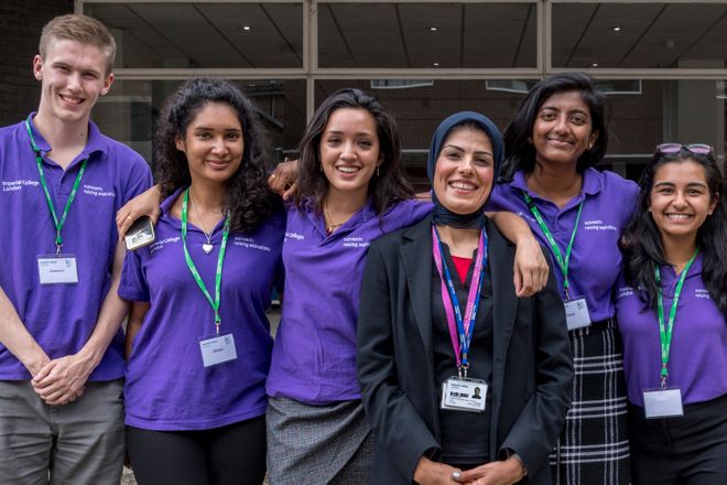 Student ambassadors and course leader standing together smiling