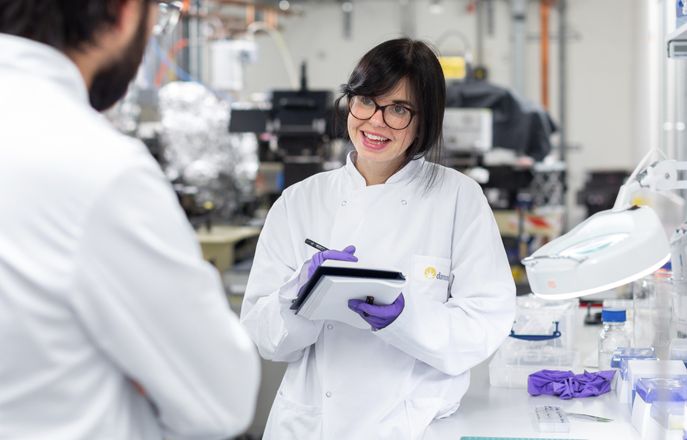 Scientist in lab taking notes