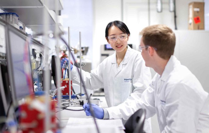 2 scientists talking in  lab