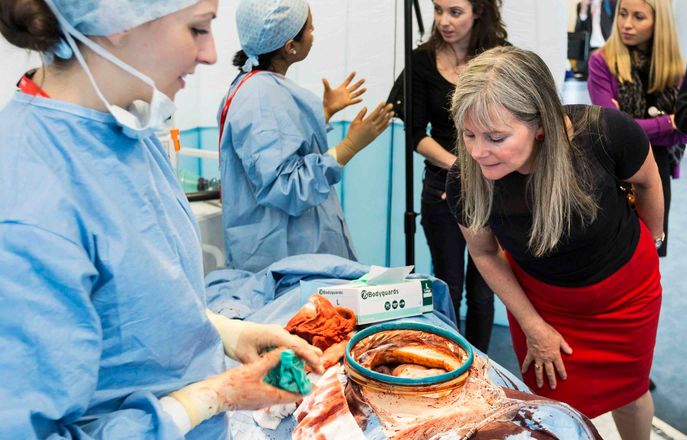 woman looking closely at simulated operation