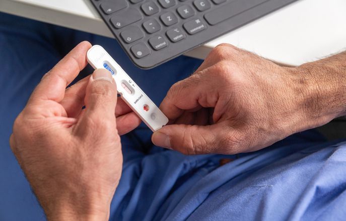 A person holding an antibody testing stick