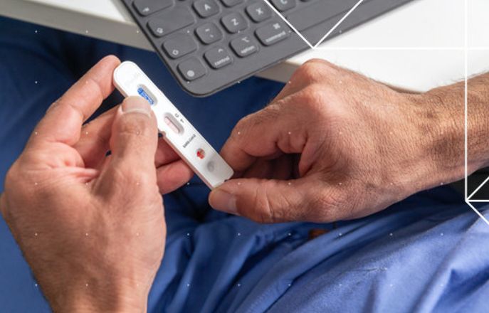 A person holding an antibody testing stick