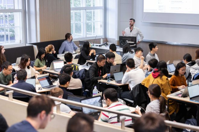 A group of students in an Applied Computational Science and Engineering lecture in the newly refurbished Royal School of Mines lecture theatre.