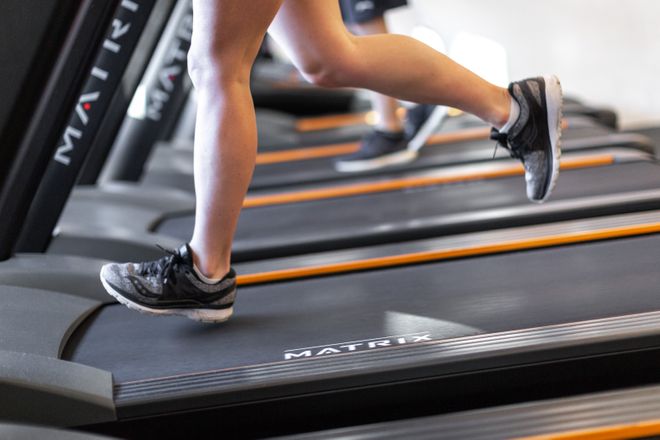 Close-up of a woman running on a treadmill at Ethos Gym