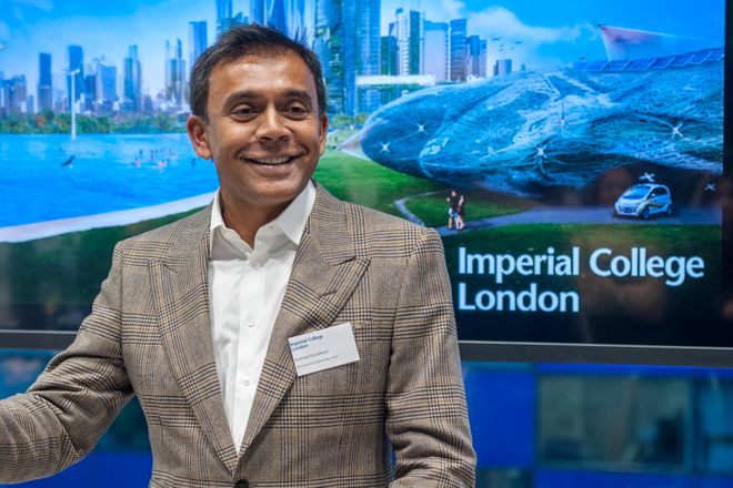 Brahmal Vasudevan standing in front of an Imperial College logo on a screen