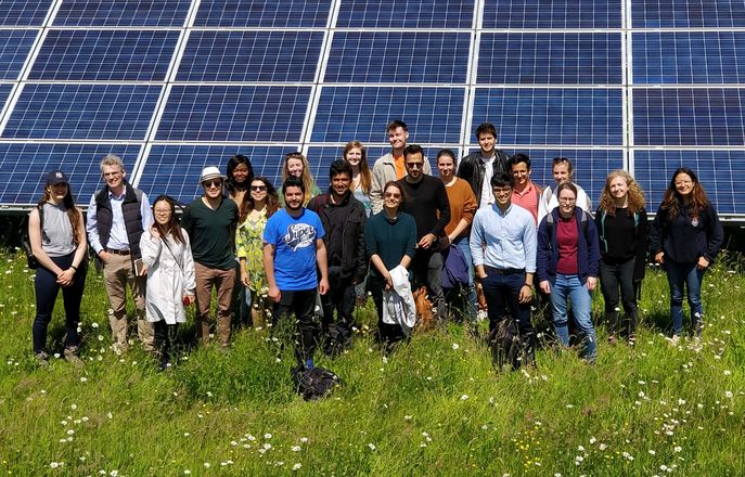 Group standing in front of solar panel