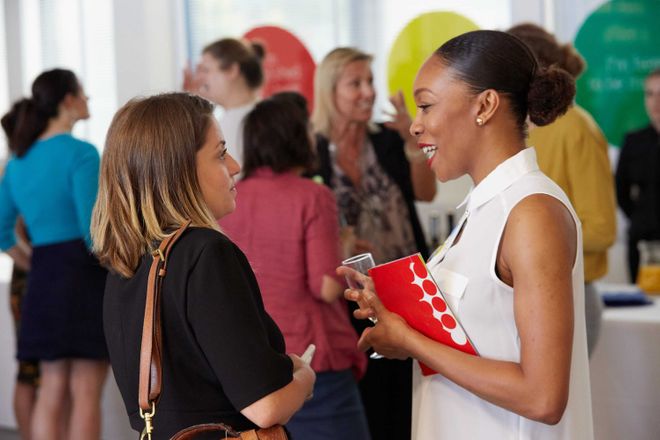 Women talking at a community networking event