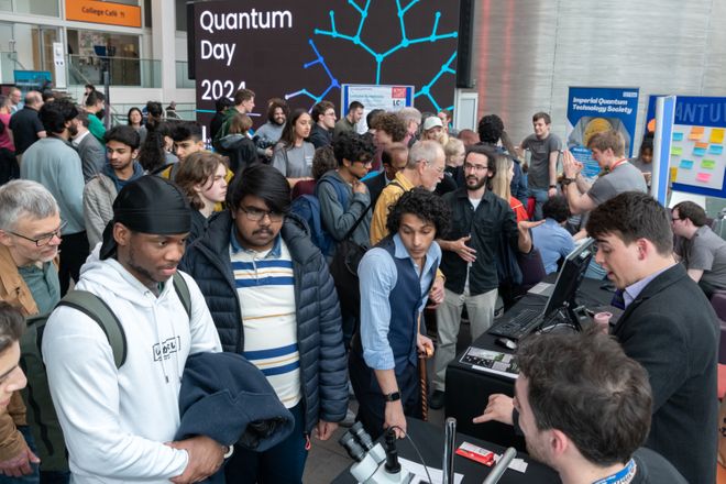 A crowd of people looking at science demonstrations