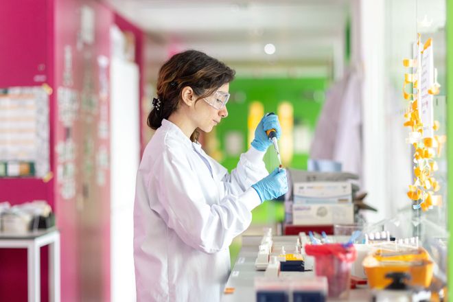 A researcher uses a pipette in a laboratory