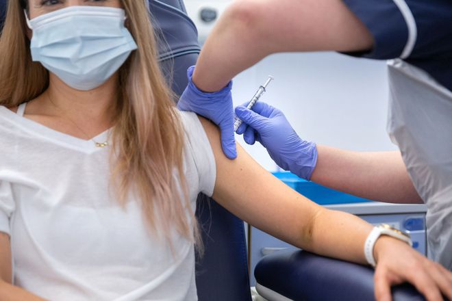 A participant in a clinical study receives the coronavirus vaccine from a nurse at Imperial College London