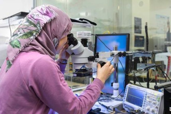 Woman looking at lab equipment