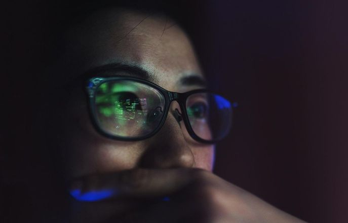 Face looking into a computer screen