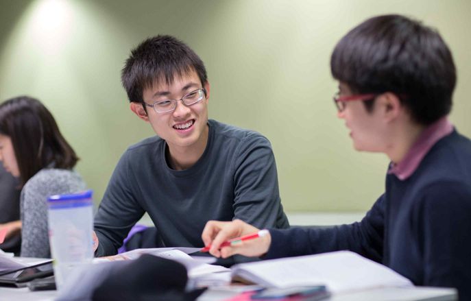 group of students sat at a desk