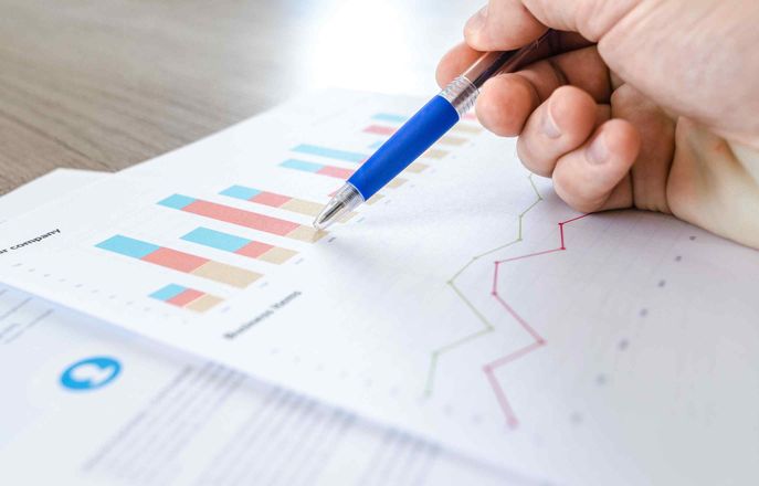 Pen pointing at graphs