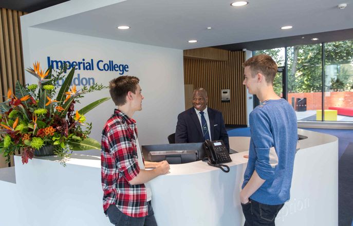 Students talking to security desk at Woodward