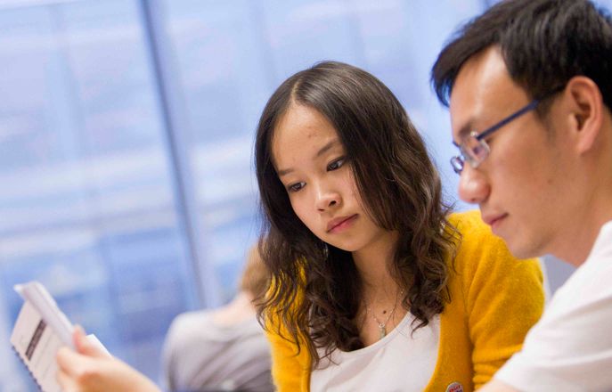 Two students reading together