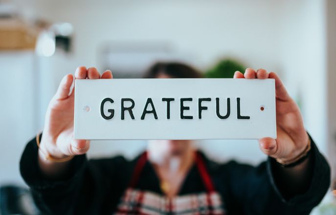 someone holding grateful sign