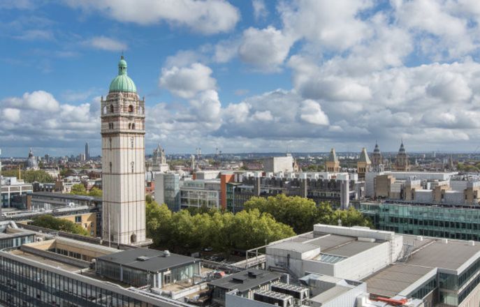 Aerial image of the South Kensington Campus with the Queen's tower on the left hand side and white clouds on a blue sky