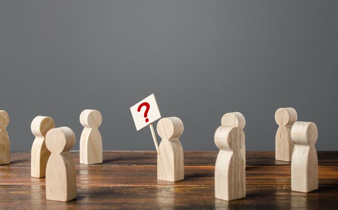 Bod holding up signpost with question mark to represent asking for help and guidance