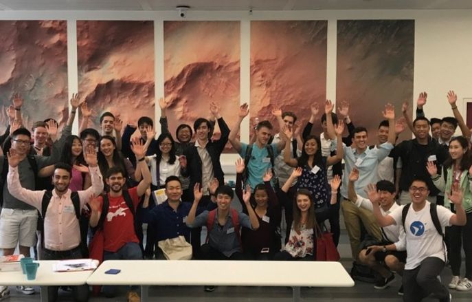 group of students waving their hands 