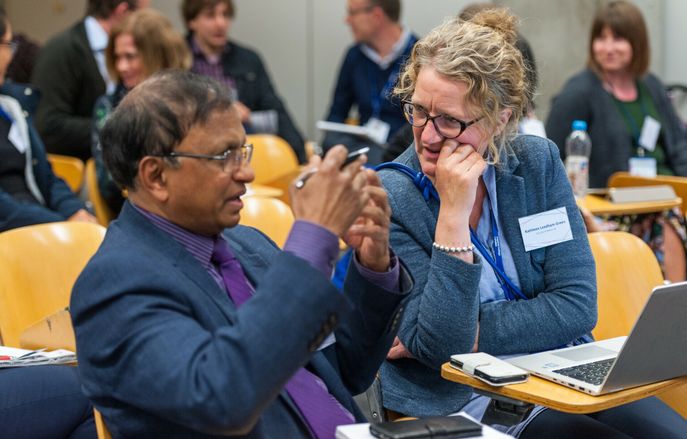 male staff and female staff member in discussion at Education day