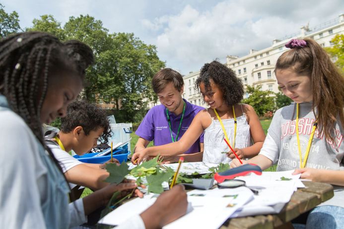 children and staff in a park during outreach