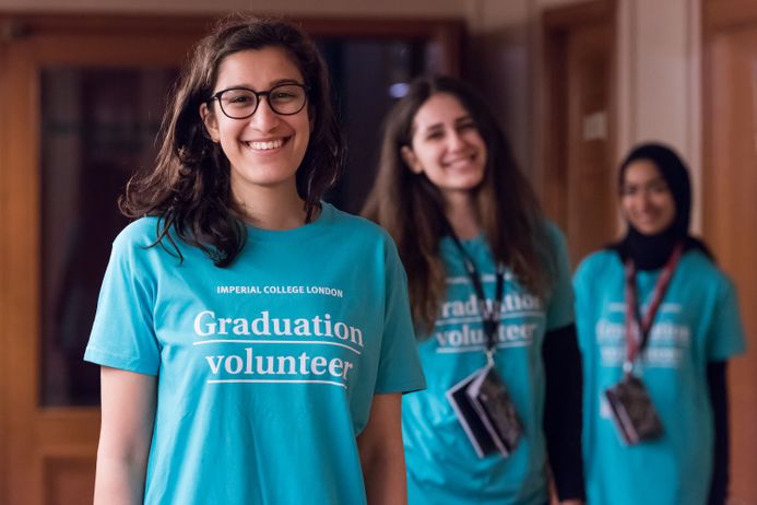 Smiling graduation volunteers