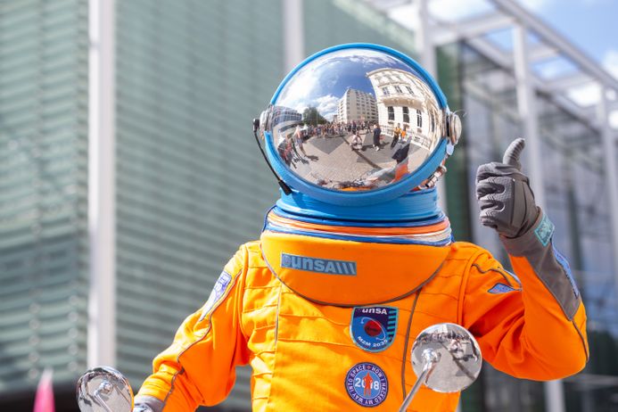 Child giving a thumbs up while wearing space suit at the Great Exhibition Road Festival