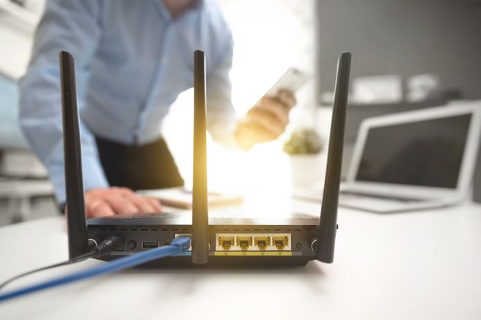 Man with smartphone and router