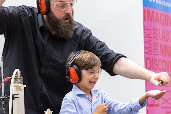 Photo of researcher and child at GERF Amazing Molecular Science Show