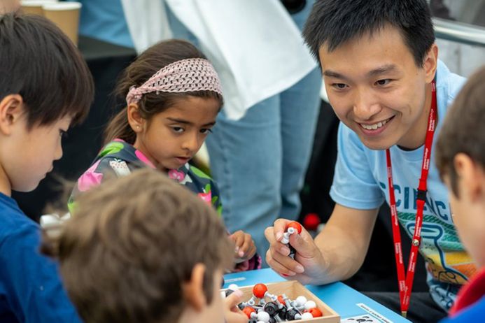 Children engage with a click chemistry exhibit at the Great Exhibition Road Festival