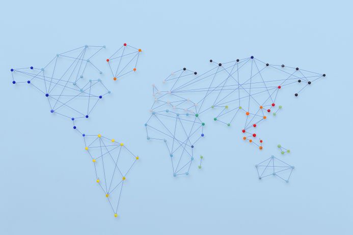 A graphic showing a simple world map connected by string and pins