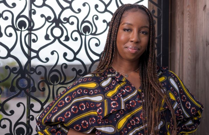 Olawunmi Olatidoye standing in front of an ornate gate