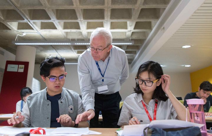 Students listening to a teacher