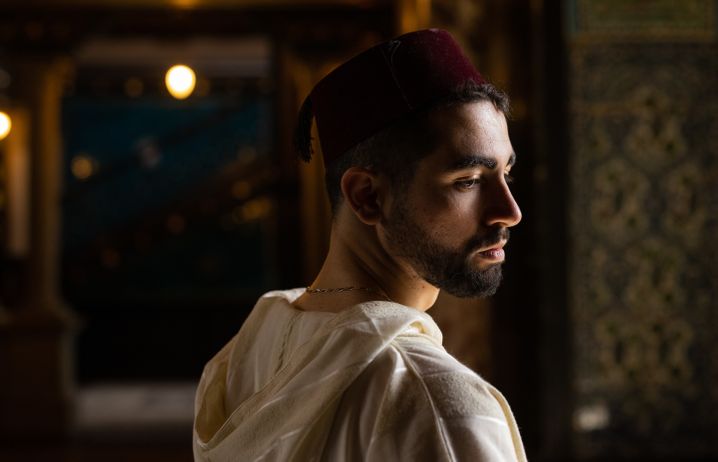 Riad Yagoubi in traditional Algerian dress in a mosque