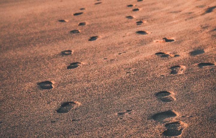 two sets of footsteps in the sand