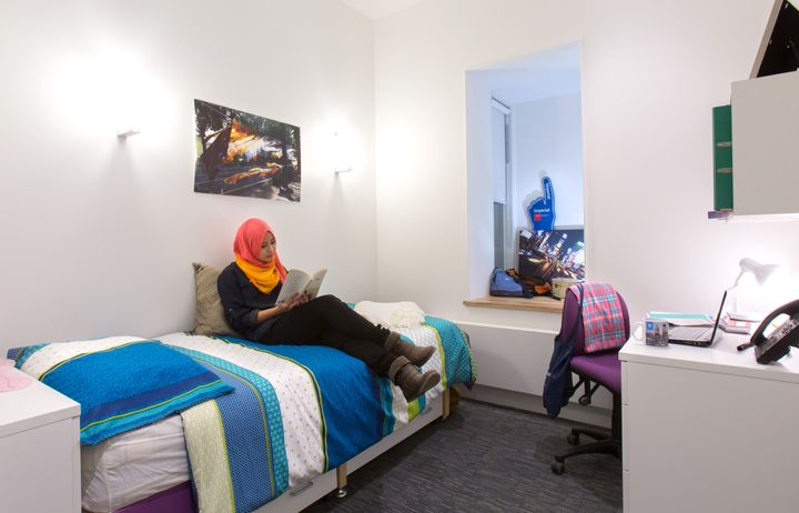 Student studying in her room in Wilson House hall
