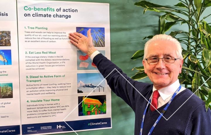 A man pointing at a climate change poster