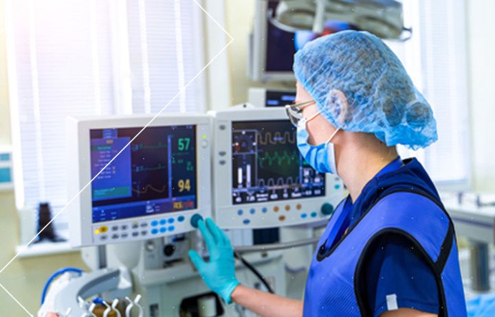 A nurse operating a ventilator