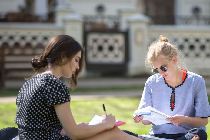 Two students sat outside