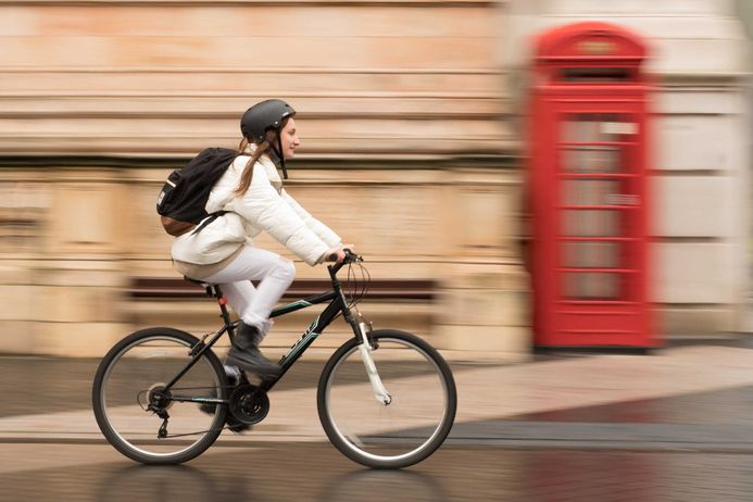 cyclist with red phone booth