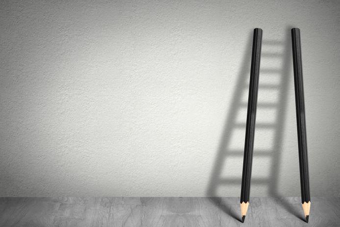 Ladder shadow, and pencils against a wall