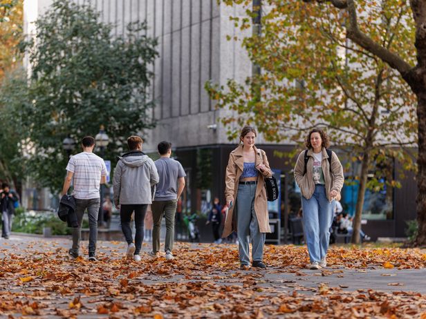Students strolling through campus in autumn